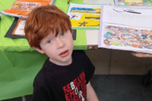 Little Boy Sitting and Looking At Something